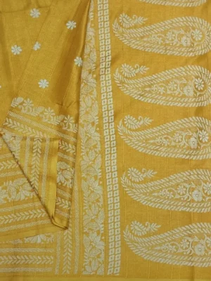 Close-up of paisley motifs and floral buttas on mustard yellow semi tussar saree