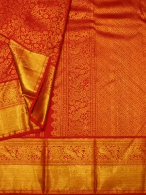 Close-up of gold zari brocade and peacock border on Crimson Red Bridal Soft Silk Saree
