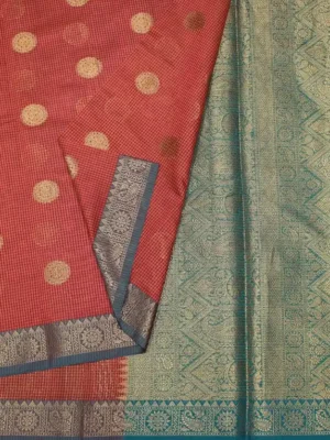 Close-up of gold zari buttas and steel blue zari border on Brick Red Semi Chanderi Saree