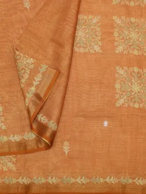 Close-up of geometric floral embroidery and tissue zari border on Copper Rust Tissue Linen Saree