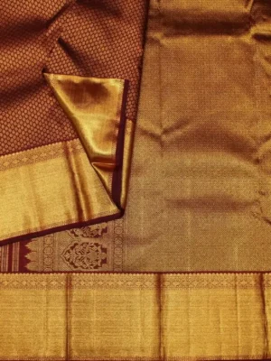 Close-up of floral gold zari brocade and tissue-style border on Deep Maroon Bridal Soft Silk Saree