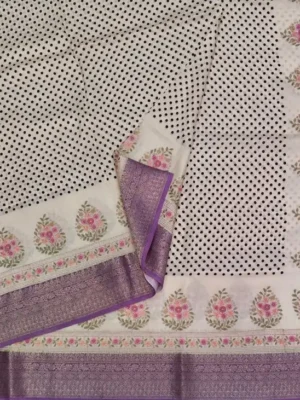 Close-up of black polka dots, floral butas and purple zari border on Cream Crepe Saree