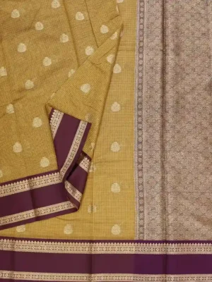 Close-up of gold zari buttas and wine brocade border on Warm Mustard Yellow Semi Chanderi Saree