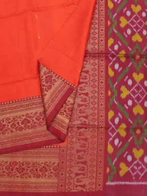Close-up of antique gold zari floral border and colourful Ikat-inspired pallu on Coral Orange Soft Silk Saree