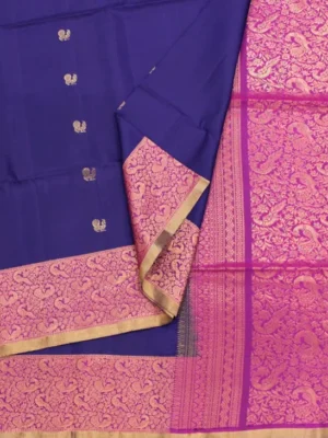 Close-up of gold zari peacock buttas and Rani pink Jacquard brocade border on Ink Blue Soft Silk Saree