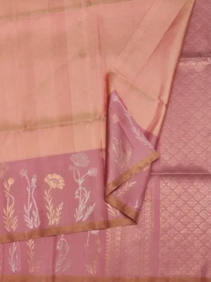Close-up of peach pink Soft Silk Saree with zari floral motifs and tissue border